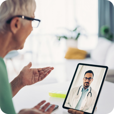 Woman talking to doctor on tablet